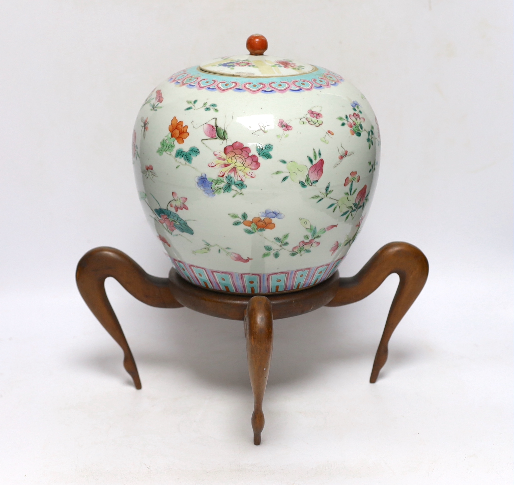 A 19th century Chinese famille verte jar and cover, on associated wooden stand, vase 22cm